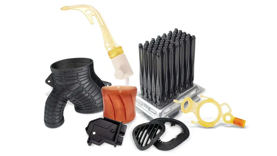 Several 3D printed parts on display with a blue background. The parts include a white gear, a colorful medical model, and other solid black and grey production parts. 