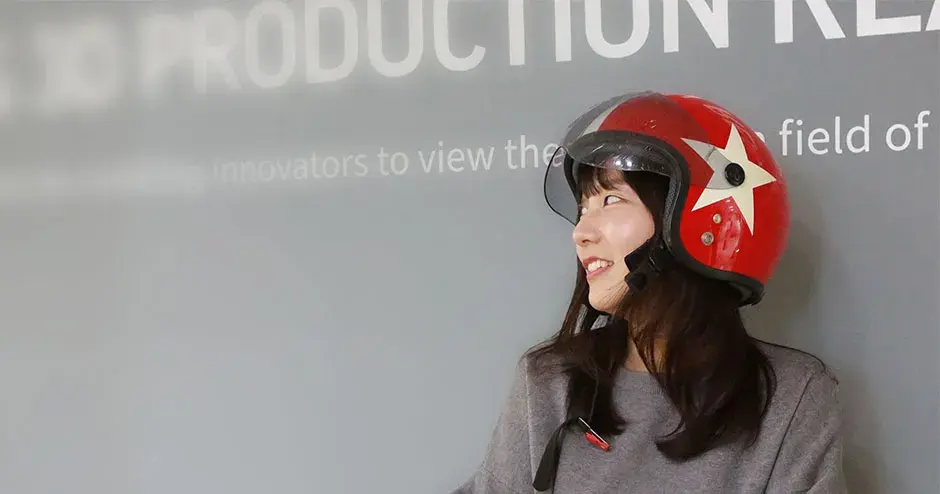 A 3D Systems employee standing next to the company's logo